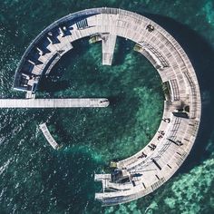 an aerial view of a circular structure in the water