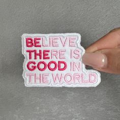 someone is holding up a small patch that says believe there is good in the world