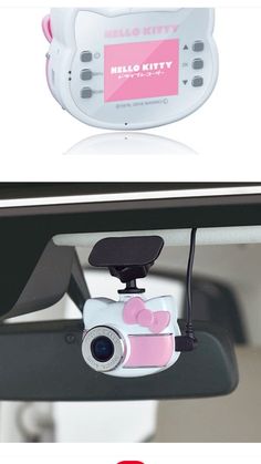 the hello kitty camera is attached to the rear view mirror, and it's pink in color