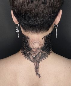 the back of a woman's neck with tattoos on it