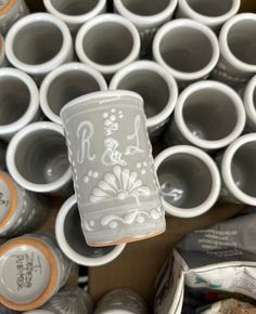 there are many cups with designs on them