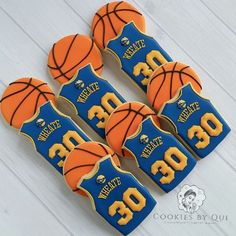 basketball cookies decorated with royal blue and gold icing