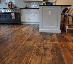 a kitchen with wooden floors and white cabinets