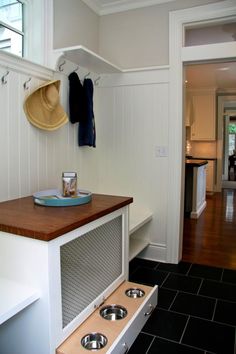 a dog house with two bowls on the counter