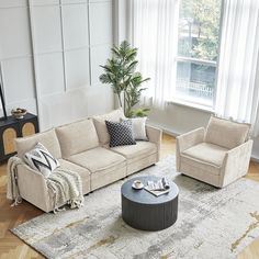 a living room with two couches and a coffee table in front of a window