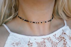 Our beautiful hand mixed seed beads with warm golds and black tones Choker is 13 inches with a 2" adjustable extender chain. 15 inches total length. Need a custom length? We are more than happy to do that for you! Please enter your custom request in the optional personalization box down below Finished with a gold plated stainless steel lobster clasp & chain. This necklace is water proof 💦  Handmade with love by Amanda Check out my shop for more chokers to layer with this one! 🧡 Black Beaded Necklaces With Gold Beads For Festival, Black Beaded Heishi Beads Necklace, Black Heishi Beads Necklace For Gift, Black Heishi Beaded Necklaces, Black Heishi Beads Jewelry, Black And Gold Beads For Festival, Black Beads With Gold Details For Festival, Gold Beaded Chain Metal Choker, Unique Gold Beaded Choker