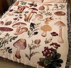 a bed covered in a quilt with mushrooms on it