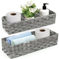 two gray baskets with towels and toilet paper on the top one is holding rolls of toilet paper