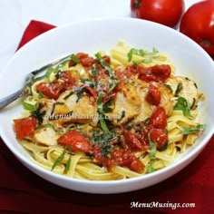 a white bowl filled with pasta and tomatoes