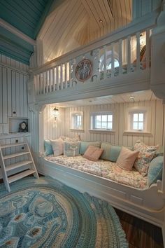 there is a bunk bed in the room with blue and white pillows on top of it