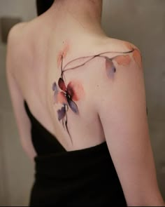 a woman's shoulder with flowers painted on it