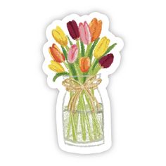 a vase filled with lots of colorful flowers