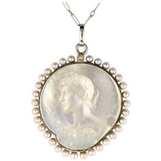 Pendant and its chain in platinum dog head hallmark. This beautiful antique medal represents the left profile of a woman, engraved on mother-of-pearl, her hair raised with a bouquet of flowers in her hands. All the entourage is in natural pearls. The chain is a figaro mesh with spring ring. Total length: about 54 cm, length of the pendant: about 3.3 cm, width: about 2.5 cm, thickness: about 2.1 mm. Total weight of the jewel: 7.90 g approximately. Numbered: 3587. Authentic antique jewel - French work of the 1920s. Our opinion: Absolutely divine, this antique pendant is delicately realized, elegant and timeless. A charming antique jewel. Specialized in antique and creation jewelry since 1975, we deliver all our jewel with their certificate of authenticity, written by our certified antique je Platinum Chain, A Bouquet Of Flowers, Antique Pendant, Antique Necklace, Bouquet Of Flowers, Mother Pearl, Accessories Jewelry Necklace, Natural Pearls, Vintage Jewellery