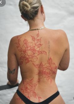 the back of a woman's body with flowers on it