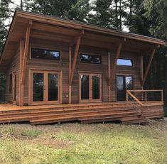 a wooden cabin with stairs leading up to it