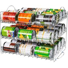 the spice rack is holding several cans of canned food