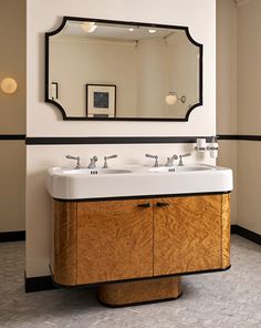 a bathroom with two sinks and a mirror