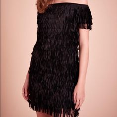 Swish And Swoosh In This Fringed Mini. It’s A Playful, Party-Ready Option You’ll Turn To All Season Long. Off-Shoulder Neckline Laser Cut Poly Fringe Sheath Silhouette Mini Length Center Back Invisible Zip Lined In Soft Jersey Dry Clean Holiday Fringe Dresses For Night Out, Evening Mini Dress With Fringe For Party Season, Flirty Fringe Mini Dress For Party, Fringe Mini Dress For Date Night And Party Season, Party Season Fringe Mini Dress For Date Night, Holiday Party Dress With Fringe, Chic Fringe Mini Dress For Night Out, Chic Fringe Dresses For Night Out, Black Party-ready Mini Dress For Spring