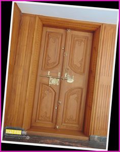 an open wooden door with decorative designs on the front and side panels, in a room