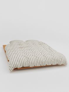 a dog bed made out of wood and ticking fabric