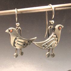 Whimsical bird earrings in mixed metals of copper and argentium sterling silver are unique and fun earrings with a bit of bohemian spirit for those that love handcrafted art jewelry that speaks to the soul.  We have oxidized and polished them to highlight and provide contrast, depth and interest between the metals and to the detailing of the riveted copper eye, sleek wing and the stamped feet. A great gift for a bird or nature lover or enthusiast along with those interested in Ornithology.  Hand Handmade Sterling Silver Bird-shaped Jewelry, Artistic Silver-colored Copper Earrings, Artistic Silver Copper Earrings, Unique Silver-colored Copper Earrings, Unique Silver Jewelry With Bird Design, Copper Eye, Silver Bird, Handcrafted Art, Bird Earrings