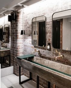 an instagram photo of a bathroom with brick walls and green counter tops, along with mirrors on the wall