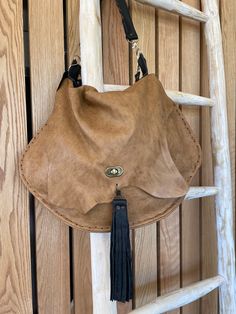 Beautiful top grain raw leather ( no lining) crossbody/shoulder bag. Slouch hobo bag with tons of room. Two straps, one crossbody and one hand or shoulder strap. All detachable. Hand/shoulder strap has a hand stitched finish as does the main body of the bag. It has a twist style metal fastener and a large leather tassel.  All of my bags are designed and made by me, all one of a kind.  I do not replicate! Leather Lined Crossbody Hobo Bag For Daily Use, Leather Hobo Bag With Removable Pouch Crossbody, On-the-go Crossbody Hobo Bag With Leather Handles, Crossbody Hobo Bag With Leather Handles For On-the-go, Textured Faux Leather Crossbody Shoulder Bag, Faux Leather Satchel Hobo Bag With Detachable Strap, Leather Crossbody Hobo Bag With Adjustable Strap, Everyday Crossbody Hobo Bag With Leather Lining, Leather Saddle Bag With Removable Pouch