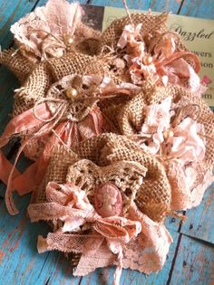 some burlap flowers are sitting on a wooden table