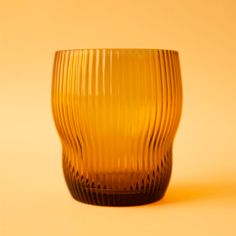 a yellow glass cup sitting on top of a table