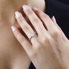 a woman's hand with a diamond ring on it