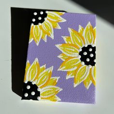 a painting of sunflowers on a purple and yellow background with polka dots in the center