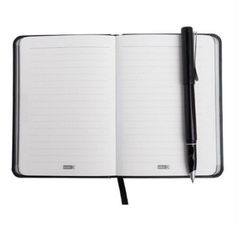 an open notebook with a pen on top