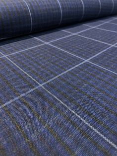 a blue plaid fabric with white lines on it