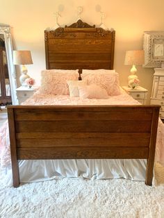 a bedroom with a bed, dresser and mirror in the corner that has white carpet on it