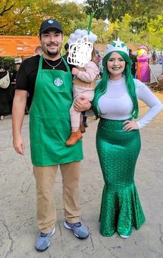 the man and woman are dressed up as mermaids