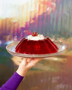 a person holding a plate with a dessert on it