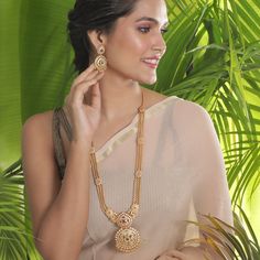 The gold beaded chain necklace that sizzles the room, this long necklace is royal charm. Excellent to pair with a kanjivaram or handloom saree. Specification: Weight - 100 gm (necklace); 19 gm (earring); Length - 36 cm (necklace); 8 cm (earring), 100% Satisfaction Guarantee:  1 Year Warranty, Long Lasting Plating, High-Quality Stones. Gifting:  This Indian long necklace set comes in a beautiful Tarinika gift box, making it an ideal gift for birthday, wedding anniversary or wedding gift.  Occasion: Perfect choice for any Indian occasion.  Care: It is advisable that you keep Tarinika products away from direct heat, humidity, and moisture. It is best to preserve your Tarinika jewelry in the box. Return/Exchange Policy:  We provide 14 days return/exchange policy. Contact us for any questions. Indian Long Necklace, Indian Jewelry Set, Long Necklace Set, Gold Necklace Indian, Necklace Set Indian, Indian Necklace, Indian Jewelry Sets, Gold Necklace Designs, Antique Necklace