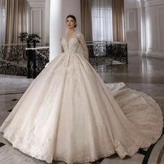 a woman in a wedding dress standing on a marble floor with columns and chandeliers