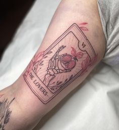 a person with a tattoo on their arm has a card in the shape of a spider