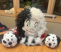 two stuffed animals sitting on top of a wooden table