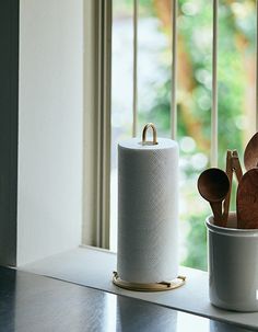 the kitchen utensils are sitting on the counter next to the window sill