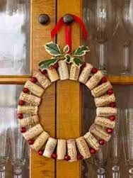 a wreath made out of wine corks with holly and red berries hanging on the front door