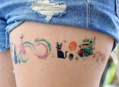 a woman's thigh with tattoos on it that say cats and dogs in different languages