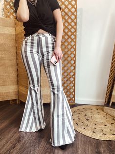 STRIPED DENIM FLARES. 98% COTTON, 2% SPANDEX. Cream/Charcoal Stripes. Stretch Flare Jeans With Frayed Hem For Summer, Striped Cotton Pants For Fall, Striped High Waist Jeans For Summer, Summer Cotton Pants With Frayed Hem, Stretch Cotton Bottoms With Frayed Hem, Cotton Pants With Frayed Hem For Summer, Summer High Rise Pants With Frayed Hem, Summer Dark Wash Pants With Frayed Hem, High Rise Summer Pants With Frayed Hem