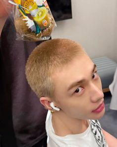 a young man is getting his hair cut