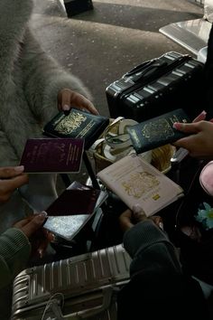 several people are holding their passports and looking at them