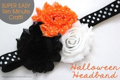 a black and white headband with an orange flower