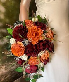 a bridal bouquet with red and orange flowers