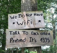 two wooden signs that say we do not have wifi and talk to each other