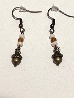 Check out these cute fall inspired dangle earrings! Simple and adorable, perfect for fall. Handmade Jewelry For Fall, Cute Single Dangle Earring, Brown Dangle Metal Earrings, Brown Metal Dangle Earrings, Cute Adjustable Drop Earrings, Elegant Fall Jewelry Gift, Elegant Fall Jewelry For Gifts, Cute Beaded Dangle Earrings With Ear Wire, Cute Dangle Beaded Earrings With Ear Wire